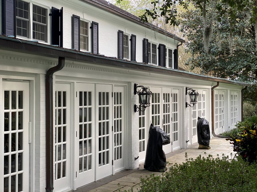 Freshly painted residential exterior with blue siding and white trim