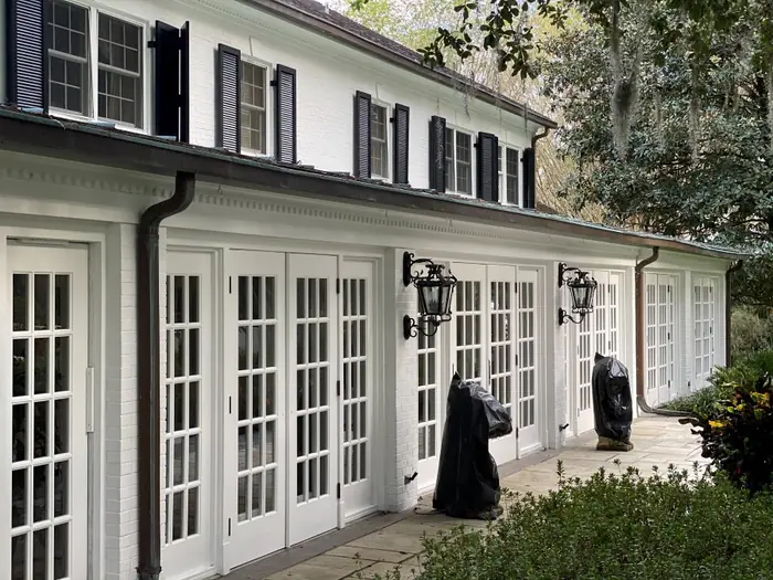Freshly painted residential exterior with blue siding and white trim