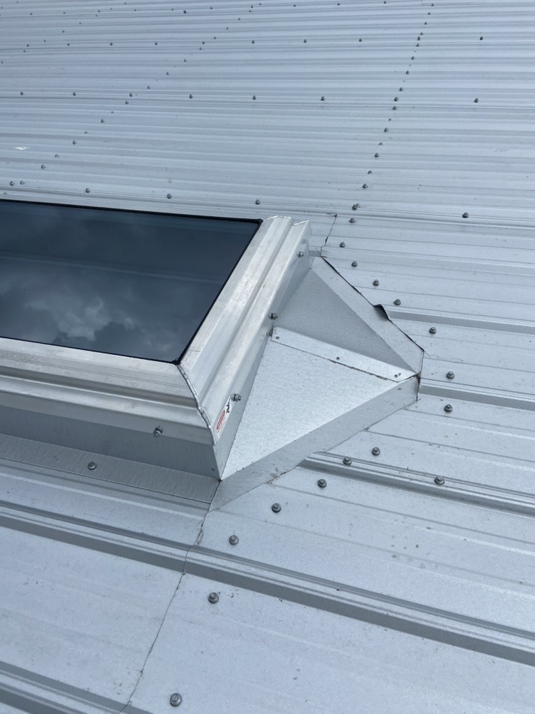 Custom skylight flashing installed on a metal roofing system