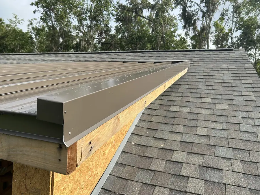 Close-up of finished shingle roof edge and eave detail