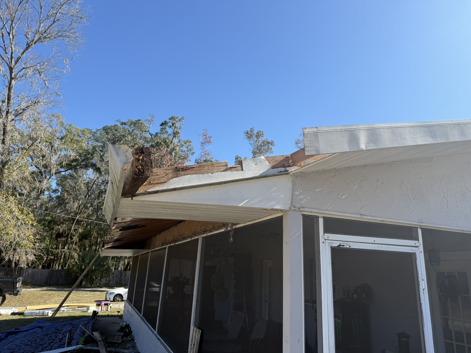 Exterior wall and roof edge damaged by a fallen limb