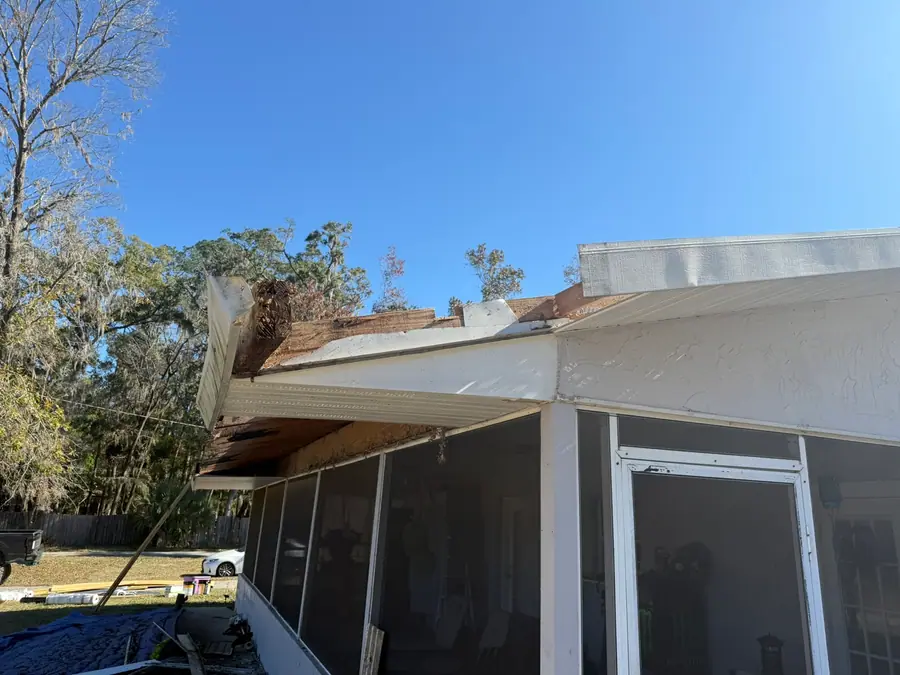 Exterior wall and roof edge damaged by a fallen limb