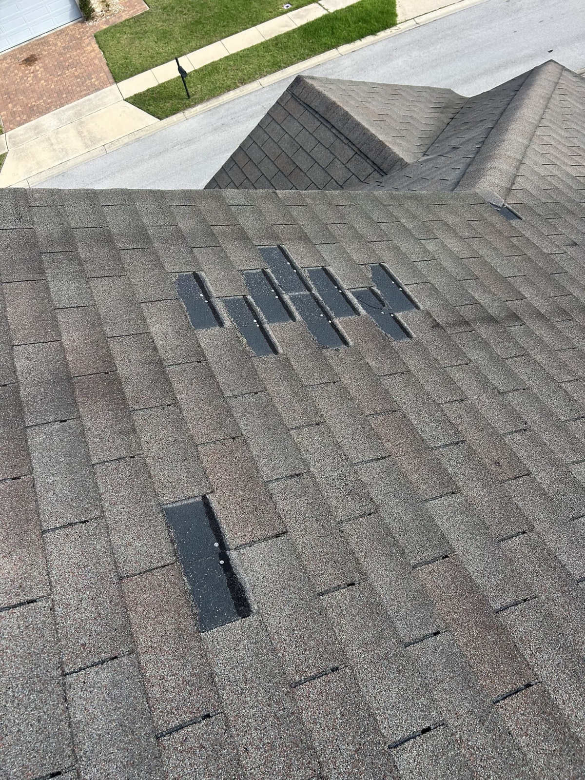 Temporary shingle repairs on a roof slope
