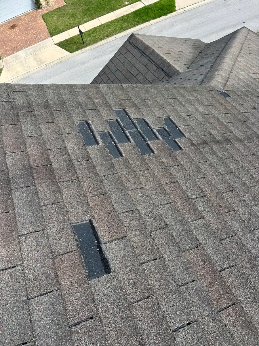 Temporary shingle repairs on a roof slope