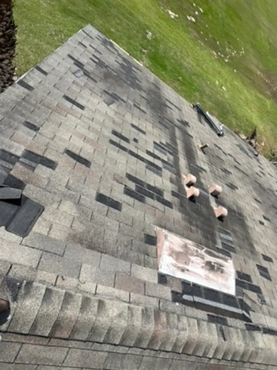 Temporary patches across a damaged shingle roof