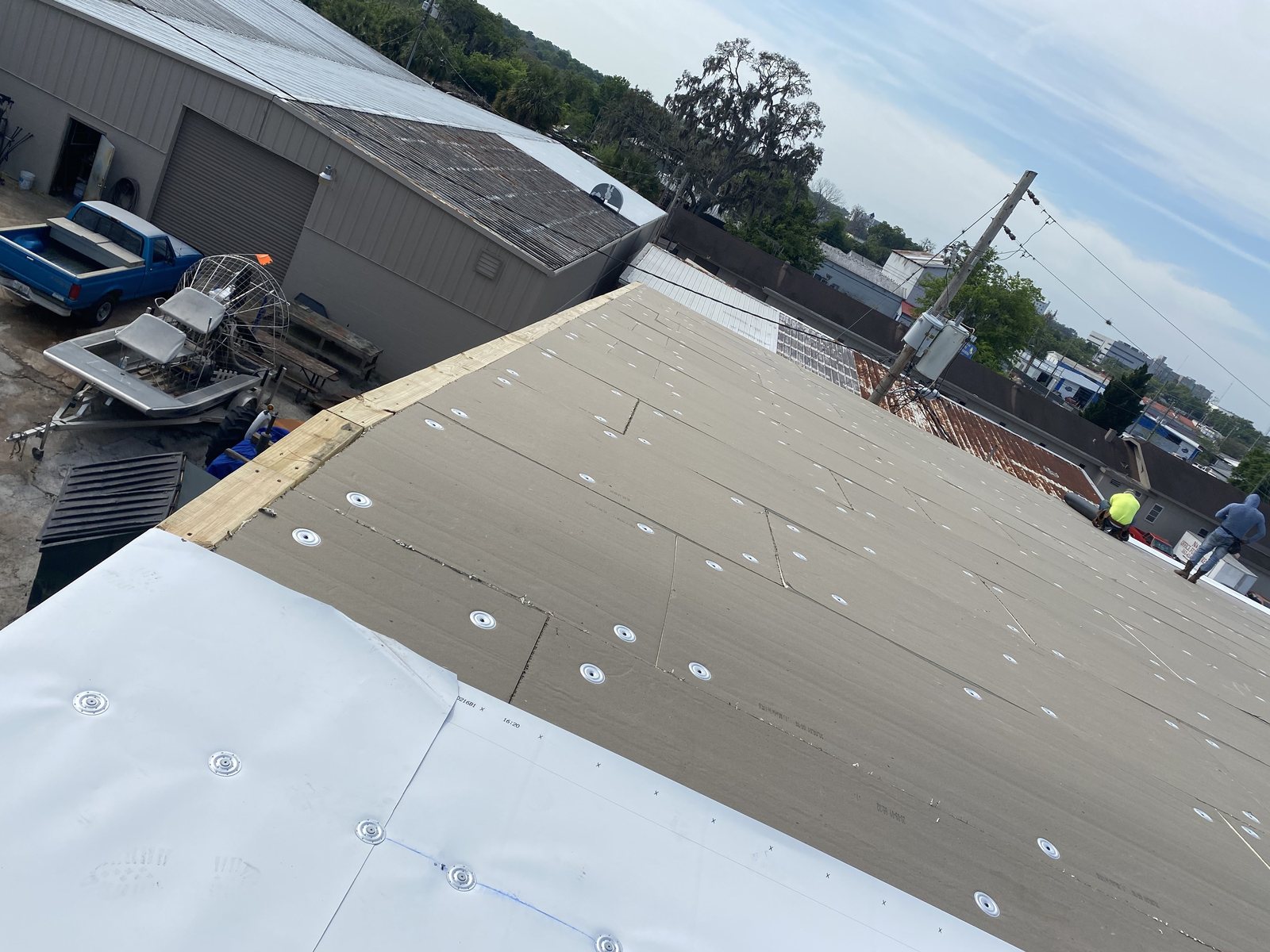 TPO membrane installation in progress on a low-slope roof